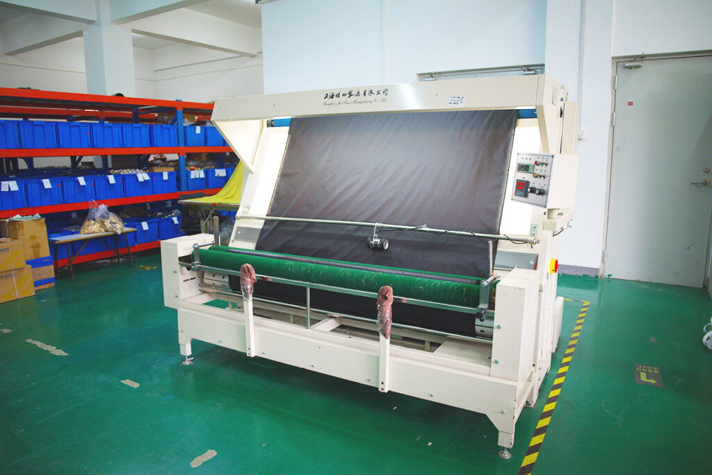 A machine used for inspectincting fabric quality inside Itorch Apparel's factory.