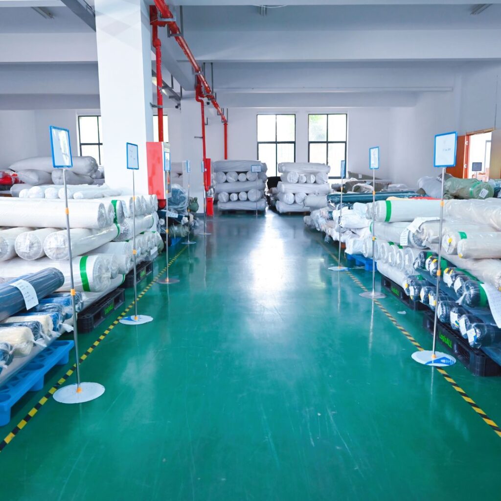 Fabric rolls warehouse at Itorch Apparel's factory.