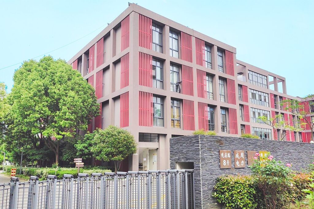 The exterior of Itorch apparel's Nanjing factory on a sunny blue sky day.