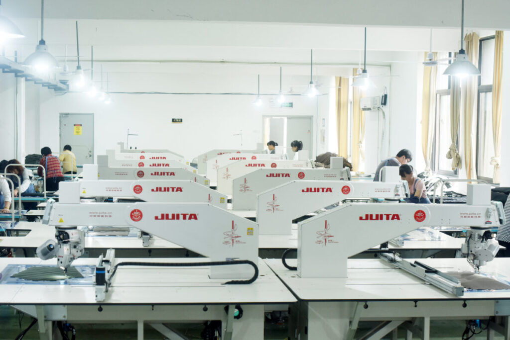 Twelve automatic quilting machines in Itorch apparel's quilting department.