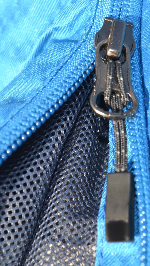 Close up image a winter jacket's vented zip with visible mesh lining.