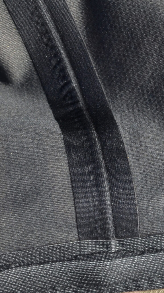 Close-up of a sealed seam in a 3 layer fabric jacket.