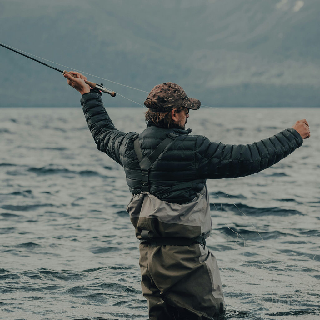 A person wearing an insulated jacket while fishing.