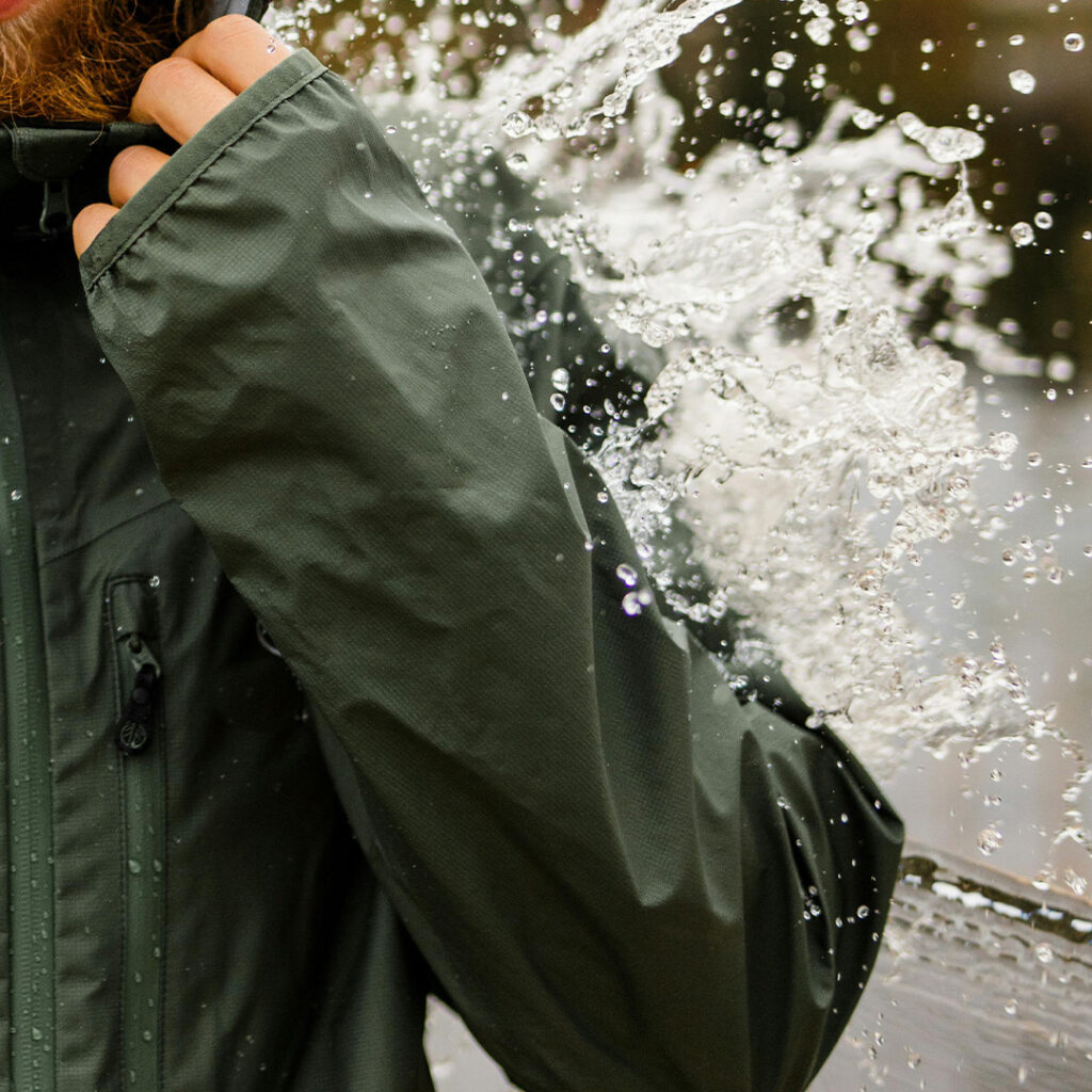 Water splashing off from a person wearing a 2.5L membrane jacket.